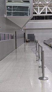 Sniffy the traveling beagle arriving in Miami, USA at baggage carousel SKUDO7