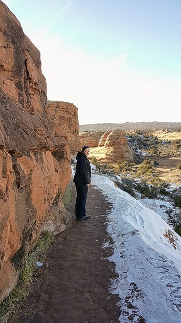 View of Delicate Arch Trail in Arches National Park during late-winter spring with snow and ice
