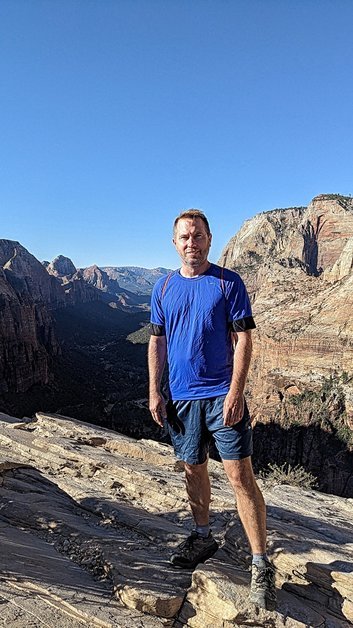 Matty standing at the summit of Angels Landing in Zion National Park